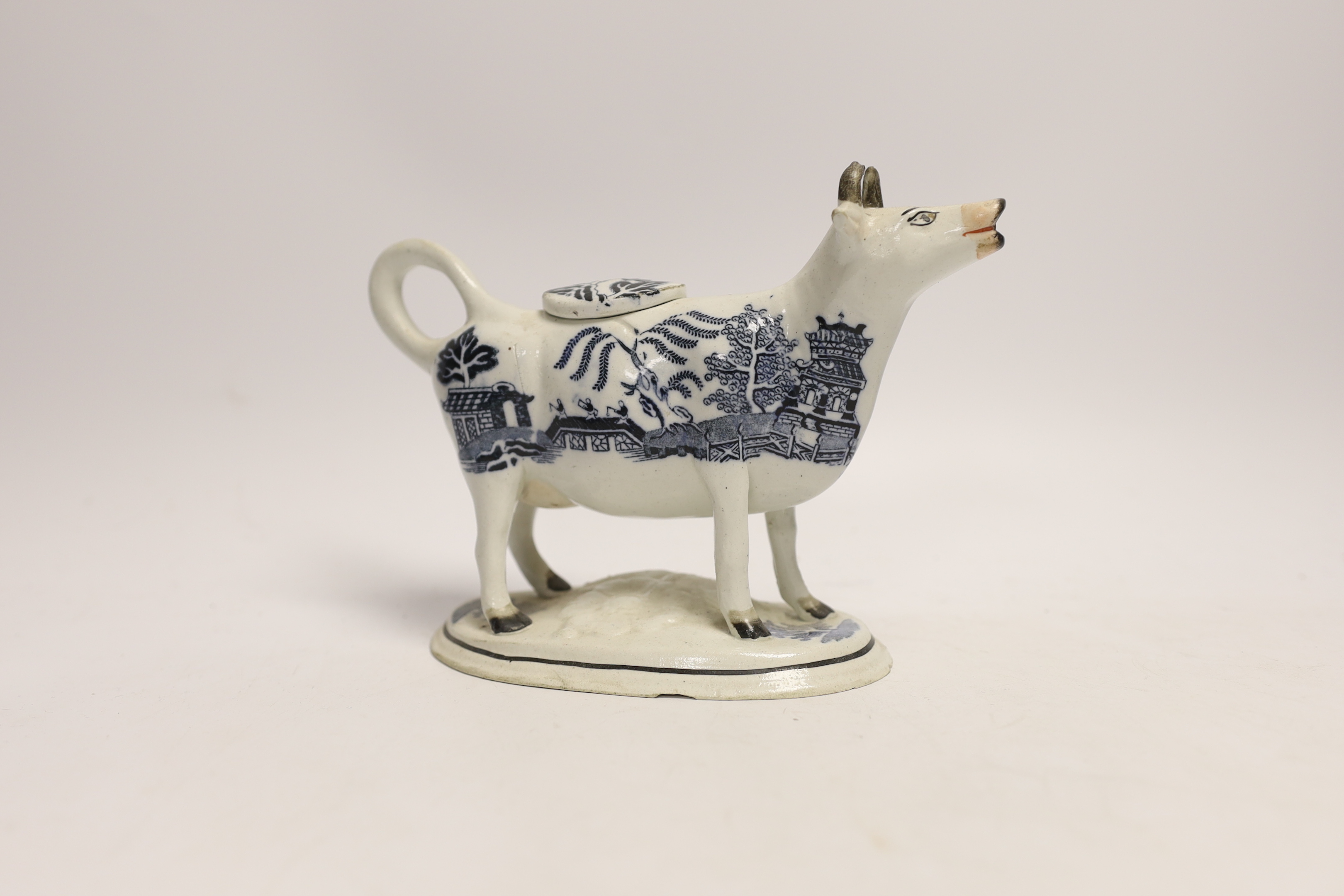 A 19th century Staffordshire porcellaneous willow pattern cow creamer, 18cm wide